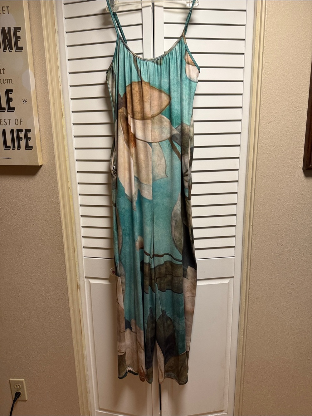 Turquoise Floral Jumpsuit w/ front pockets.